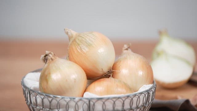 Fresh Onions in a Bowl on a Kitchen Countertop