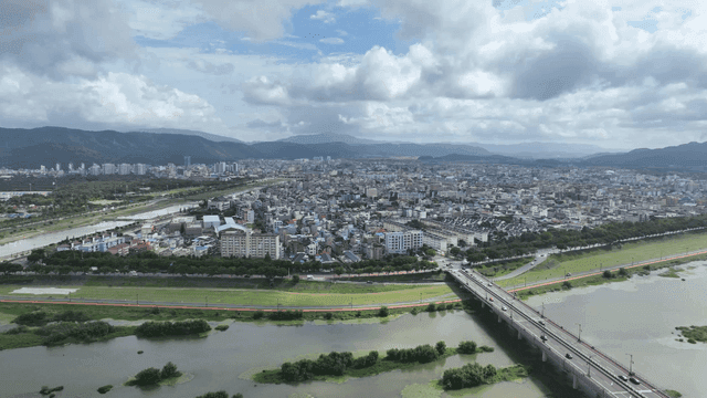 Sprawling city with a river and bridge