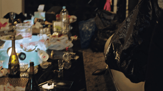 People cleaning a messy club room