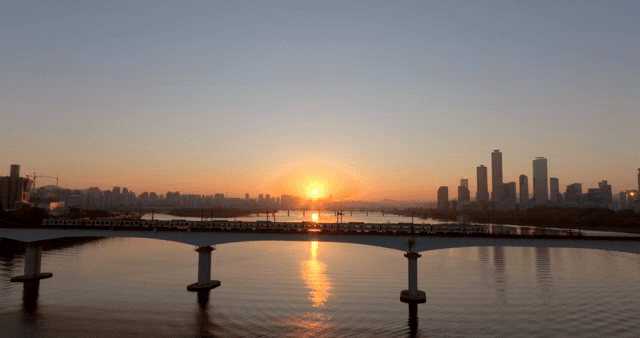 Bridge over a river with city skyline