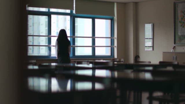 Student Gazing Outside Classroom Window