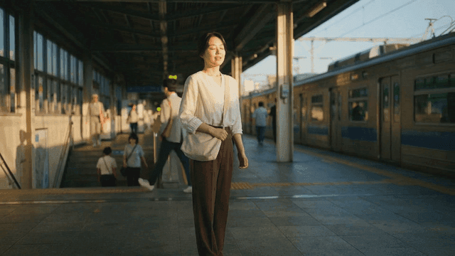 A woman standing on a train platform