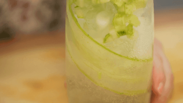 Sparkling water poured into refreshing cucumber ade