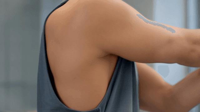 Man stretching arms indoors