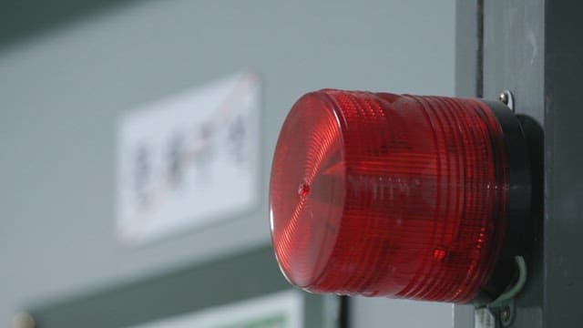 Red siren lights installed in restricted area inside industrial facilities