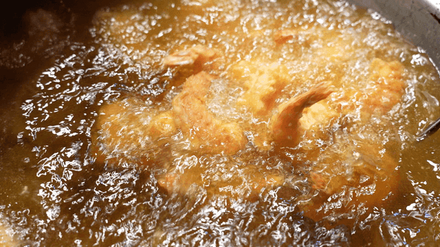 Shrimp being fried in hot oil