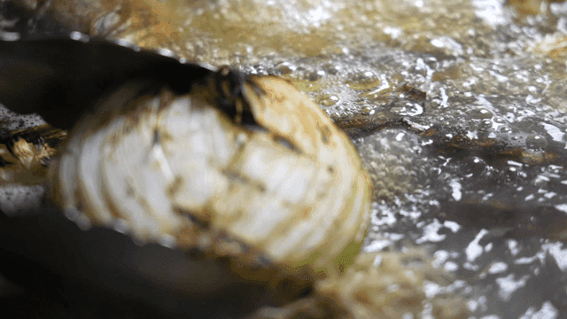 Grilled onions added to boiling broth