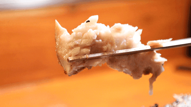 Grilled fish picked up with chopsticks