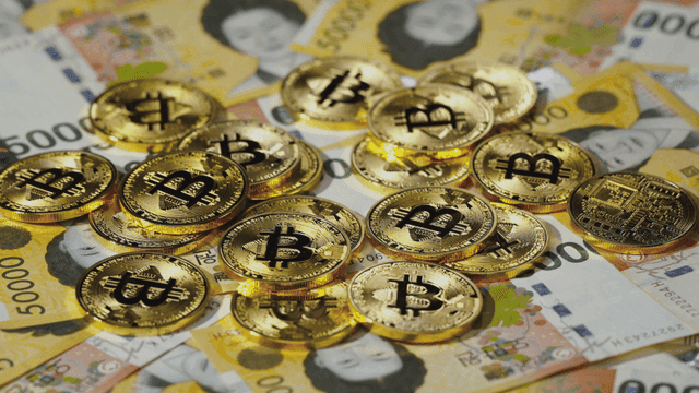 Bitcoin coins on Korean currency notes