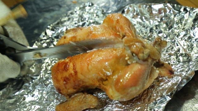 Wood-fired whole chicken stuffed with nurungji being sliced open