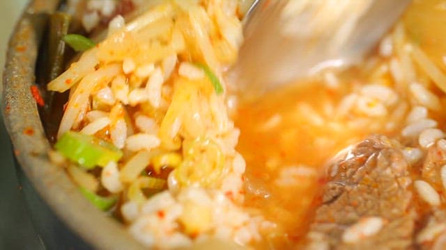 Beef and rice soup in an earthen pot