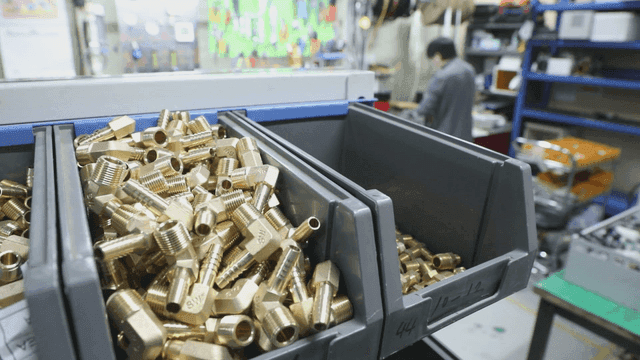 공방 작업대 위 황동 부품 통