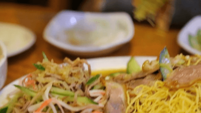 Chopsticks picked up braised pig's feet and cucumber