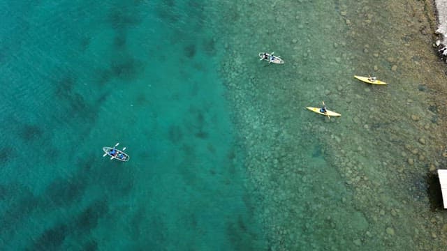 People kayaking on the lakeside