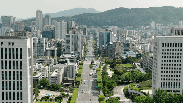 Bustling city with tall buildings and greenery