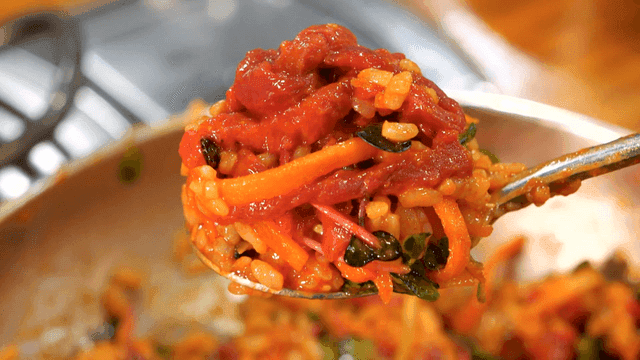 Seasoned yukhoe bibimbap scooped with spoon