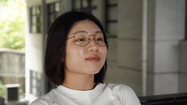 Woman wearing glasses smiling outdoors