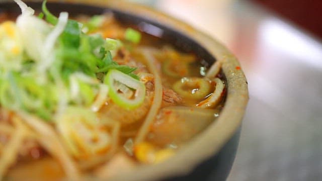 Beef and rice soup in an earthen pot