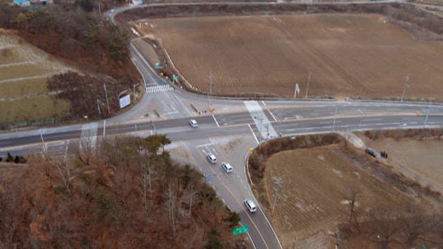 Vehicles Dispersing at a Countryside Intersection