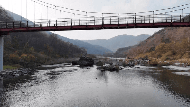 Quiet river with suspension bridge