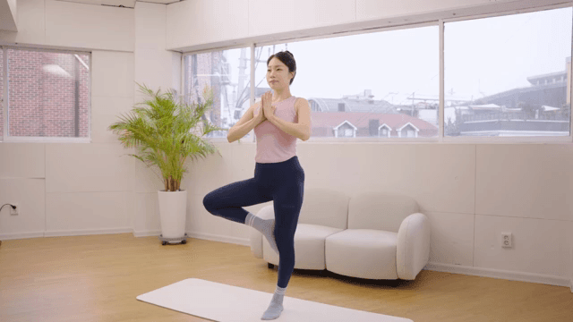 Woman practicing yoga indoors