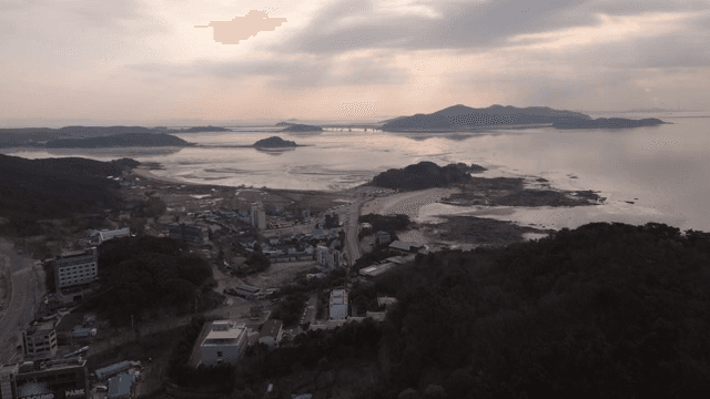 Coastal village with distant mountains