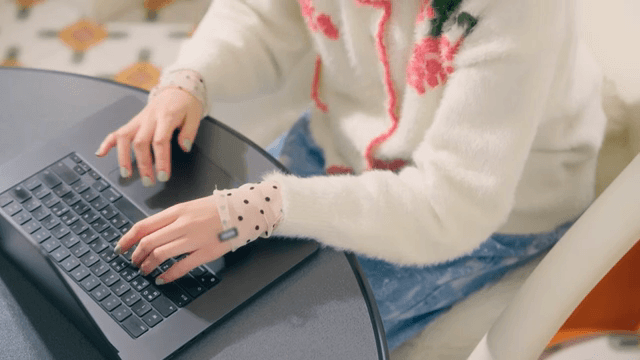 Person typing on a laptop indoors