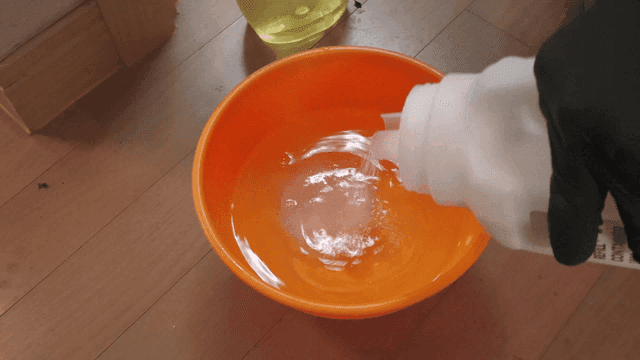 Sodium percarbonate poured into orange bowl at home