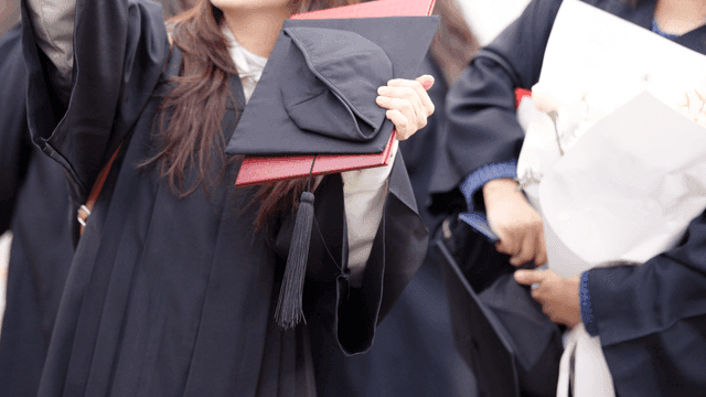 Graduates celebrating with diplomas
