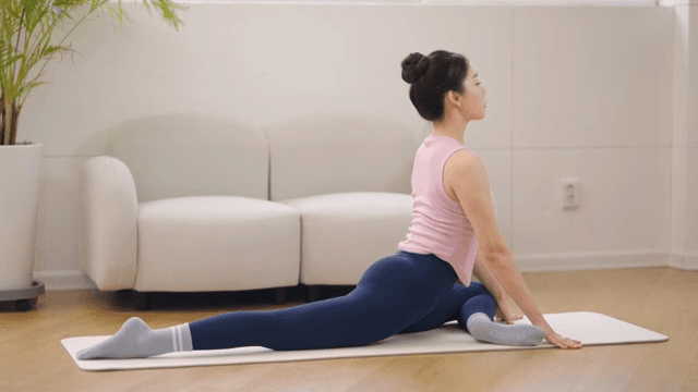 Woman stretching indoors