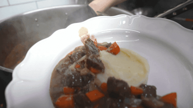 Mashed potatoes and poured beef stew