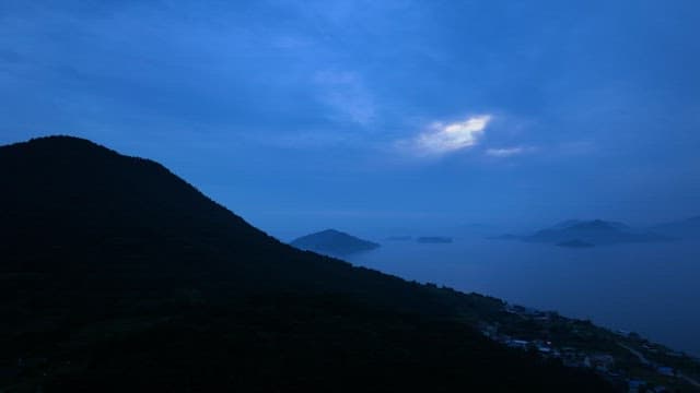 Mountains and Sea in Serene and Blue Dawn