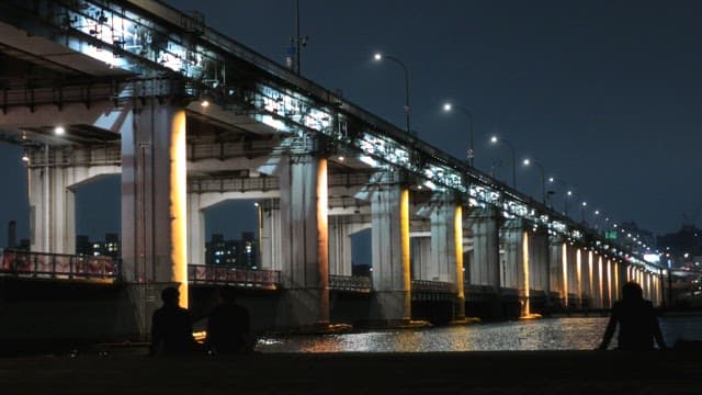 Riverside Night View with People Relaxing
