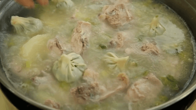 Dumplings being added to boiling soup