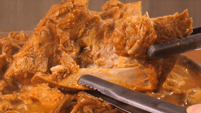 Pork backbone stew topped with sweet potato stems