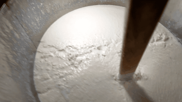 Soy milk being stirred in large pot