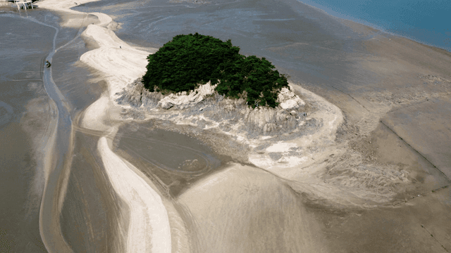 Small island surrounded by mudflats