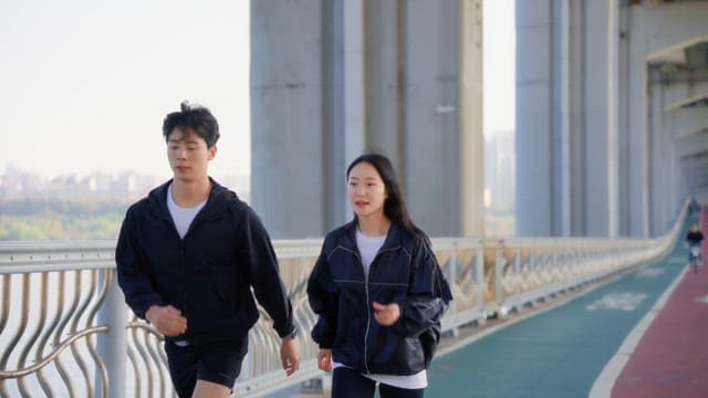 Couple jogging on a jamsu bridge