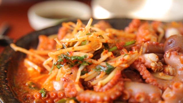 Spicy seasoned braised octopus  with bean sprouts being boiled