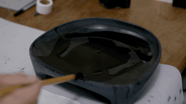 Hand applying ink to brush