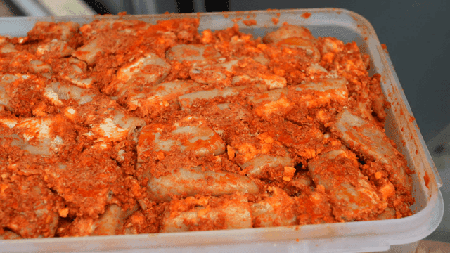Seasoned beef intestines portioned in plastic container