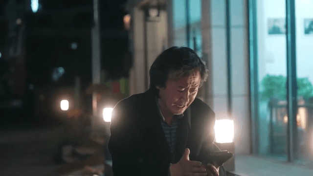 Man looking at smartphone and crying