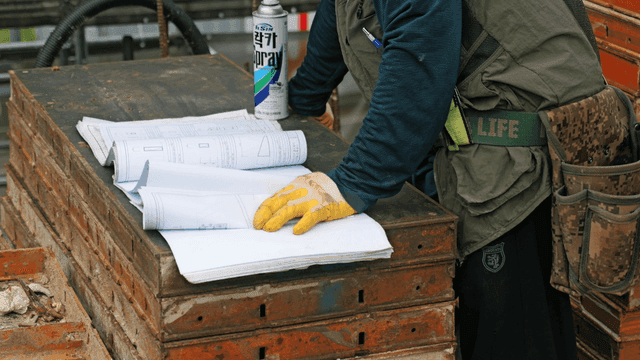 Construction worker reviewing blueprints