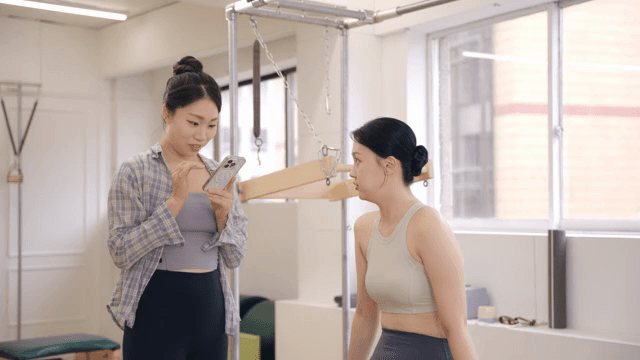 Two women discussing in a fitness studio
