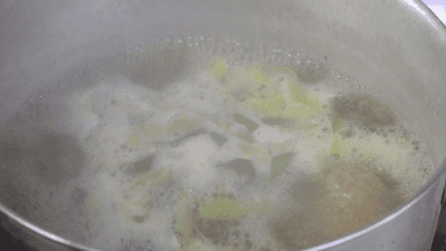Vegetables boiling in a pot on a stove