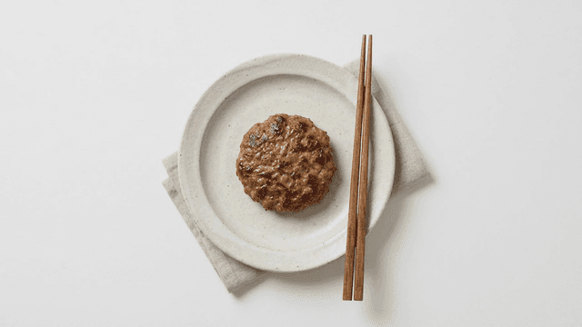 Tteokgalbi placed on plate along with chopsticks