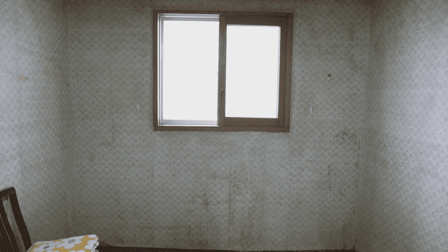 Empty room with a window and chair