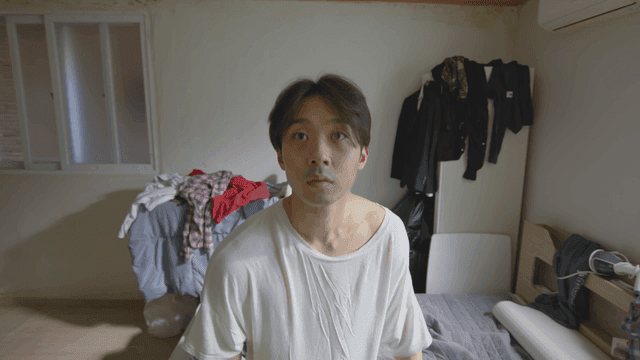 Person waking up in a messy room