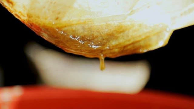 녹은 밀랍을 거름 천에 부어 거르는 모습