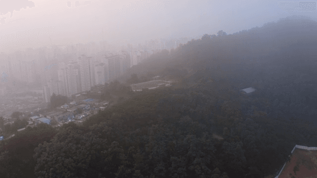 Foggy cityscape with surrounding mountains